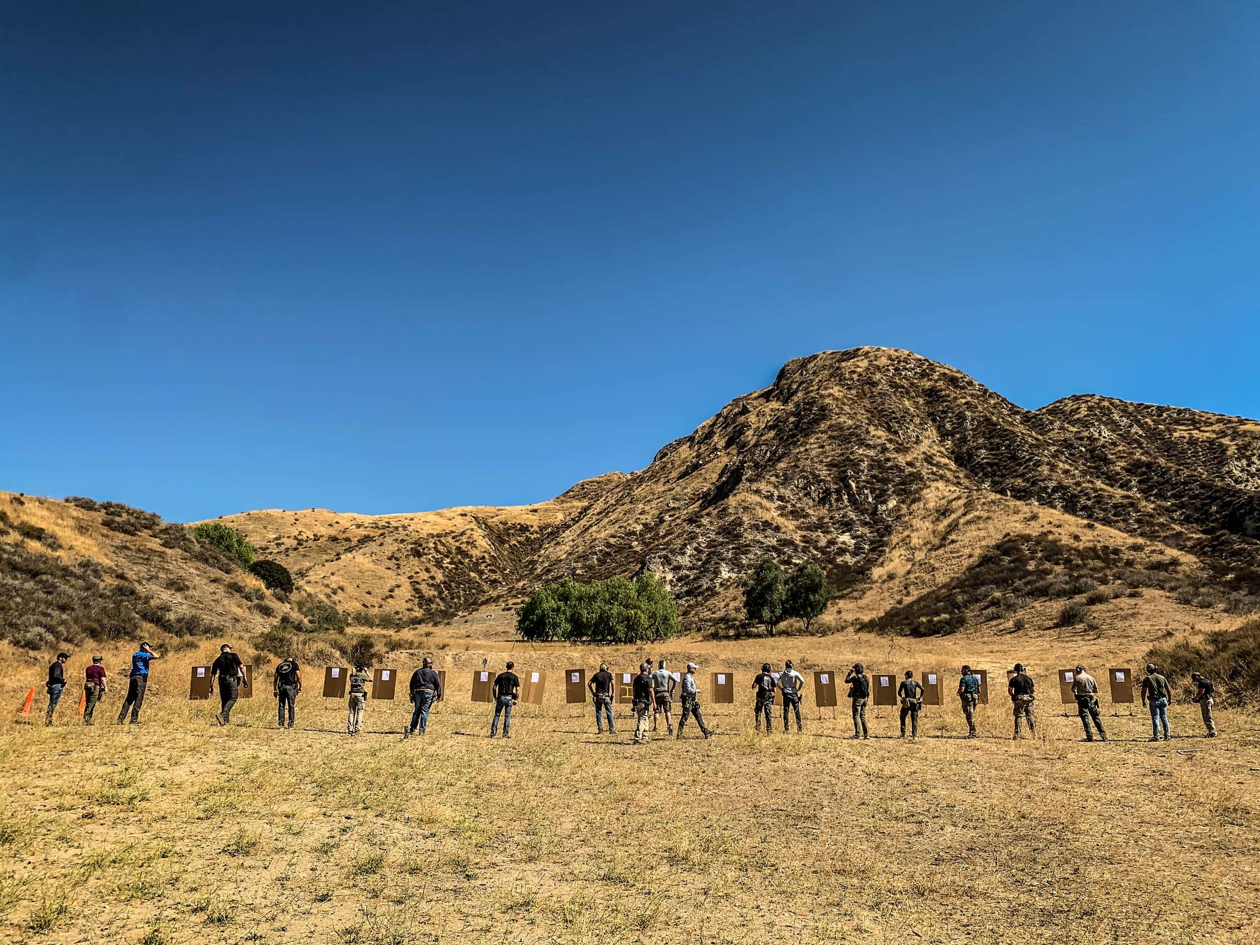 A wide firing line running a serial with mountains behind