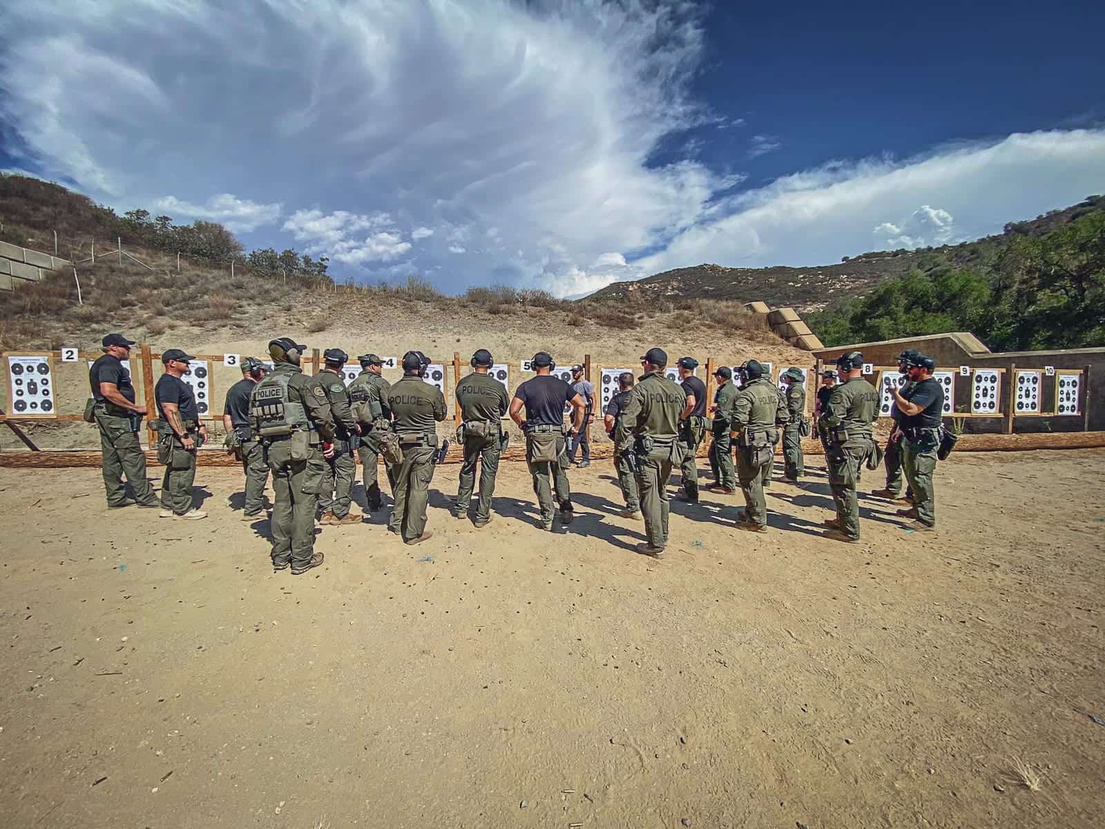 Students formed up on an open range under a broken sky