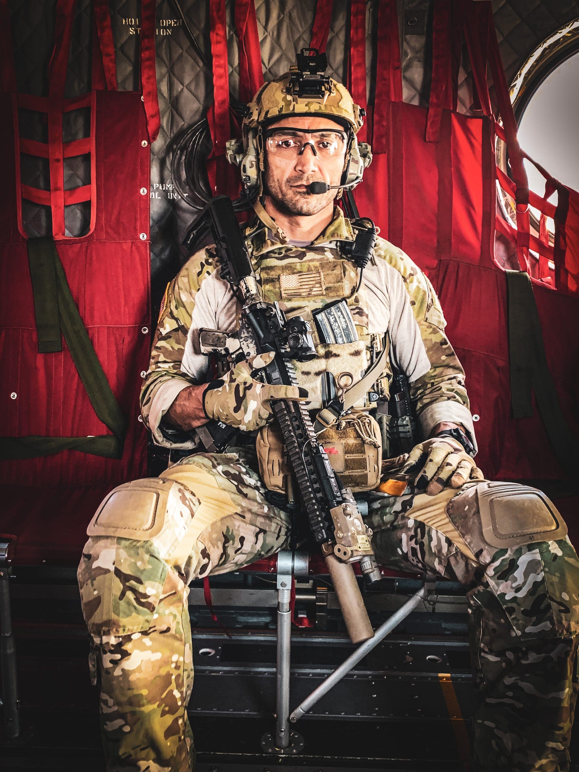 Kawa Mawlayee in full kit, photographed against a red studio backdrop
