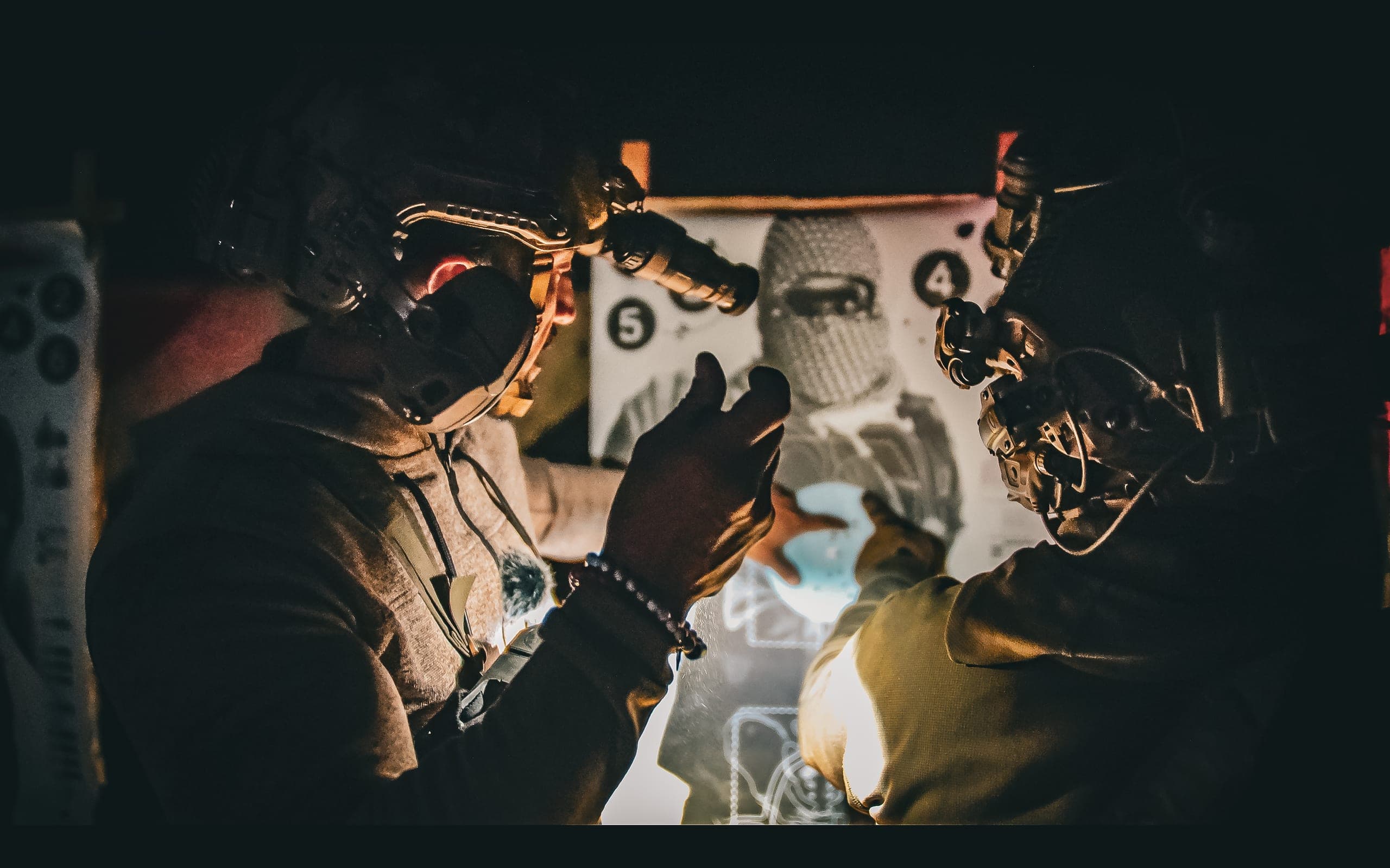 Team stacked at a doorway during a night close-quarters drill